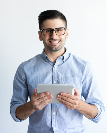 Portrait of cheerful excited tablet user wearing eyeglasses